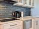 Contemporary kitchen with quartz countertops, black backsplash, and stainless steel appliances at 935 S Atlantic Ave # 244, Daytona Beach, FL 32118