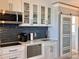 Modern kitchen with white cabinets, sleek appliances, and stylish backsplash at 935 S Atlantic Ave # 244, Daytona Beach, FL 32118