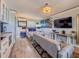 Stylish condo with a living room and kitchen combo, complemented by modern beach-themed artwork at 935 S Atlantic Ave # 244, Daytona Beach, FL 32118