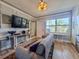 Comfortable living room with a view of the pool, featuring a cozy sofa and modern amenities at 935 S Atlantic Ave # 244, Daytona Beach, FL 32118