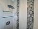 Close up of modern shower design with glass shelving and wall tile details at 935 S Atlantic Ave # 244, Daytona Beach, FL 32118