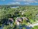 Aerial view shows the house nestled in a green area near a lake, highlighting its community setting at 9455 Belmont Ter, Oviedo, FL 32765
