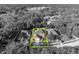 Aerial view showcasing home, with nearby lake and surrounding lush greenery in monochrome at 9455 Belmont Ter, Oviedo, FL 32765