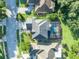 Birds eye view showcasing the home's roof, screened pool, driveway and verdant surroundings at 9455 Belmont Ter, Oviedo, FL 32765