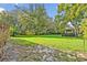 Spacious backyard featuring lush green lawn and mature trees, creating a serene outdoor space at 9455 Belmont Ter, Oviedo, FL 32765