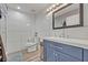 Bathroom featuring modern vanity, white tile walls, wood-look flooring, and sleek fixtures at 9455 Belmont Ter, Oviedo, FL 32765