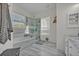 Bright bathroom features soaking tub, glass shower, and neutral tile at 9455 Belmont Ter, Oviedo, FL 32765
