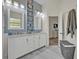 The bathroom features a double vanity, white cabinets, and a large mirror at 9455 Belmont Ter, Oviedo, FL 32765
