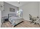 Bedroom with natural light, wood floors, ceiling fan, and stylish gray and white décor at 9455 Belmont Ter, Oviedo, FL 32765