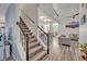 Bright foyer with wood stairs and banister leads to open concept floor plan at 9455 Belmont Ter, Oviedo, FL 32765