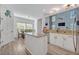 Open-concept kitchen with an island, stainless steel appliances, and an adjacent dining area at 9455 Belmont Ter, Oviedo, FL 32765