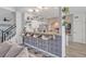 Open-concept kitchen with barstool seating, brickwork backsplash, floating shelves, and stainless appliances at 9455 Belmont Ter, Oviedo, FL 32765