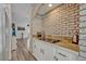 Bright kitchen features stainless appliances, granite countertops and brick accent wall at 9455 Belmont Ter, Oviedo, FL 32765