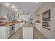Bright kitchen with granite countertops, stainless appliances, an island, and brick accented oven at 9455 Belmont Ter, Oviedo, FL 32765