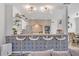Kitchen features a breakfast bar with modern pendant lighting, granite countertops, and white cabinetry at 9455 Belmont Ter, Oviedo, FL 32765