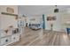 Bright living room featuring wood-look floors, neutral walls, a stylish gray sofa, and backyard views at 9455 Belmont Ter, Oviedo, FL 32765