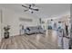 Open living room with stylish furniture, wood-look floors, and a modern ceiling fan at 9455 Belmont Ter, Oviedo, FL 32765