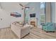 Bright living room with cathedral ceilings, a brick fireplace, and a ceiling fan at 9455 Belmont Ter, Oviedo, FL 32765