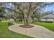 Relaxing park featuring mature trees, a winding sidewalk, and comfortable benches for peaceful outdoor enjoyment at 9455 Belmont Ter, Oviedo, FL 32765