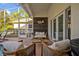Relaxing screened patio with stylish seating, wood accent wall, and view of the backyard at 9455 Belmont Ter, Oviedo, FL 32765