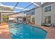Backyard pool with screened enclosure and covered patio at 9455 Belmont Ter, Oviedo, FL 32765