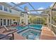 Spacious pool area featuring a spa, lounging area, and lush backyard at 9455 Belmont Ter, Oviedo, FL 32765