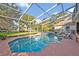 Enclosed pool with spa, lounge chairs, and lush landscaping at 9455 Belmont Ter, Oviedo, FL 32765