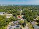 Aerial view of the home in a neighborhood near the water with mature trees at 1002 S Locust Ave, Sanford, FL 32771
