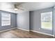 Spacious bedroom featuring two windows, wood-look flooring, and neutral paint at 1002 S Locust Ave, Sanford, FL 32771