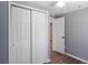 Bedroom features a closet with large, bright, bi-fold doors and wood flooring at 1002 S Locust Ave, Sanford, FL 32771