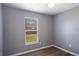 Bedroom with wood-look flooring, gray walls, and a window at 1002 S Locust Ave, Sanford, FL 32771