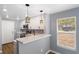 Updated kitchen featuring modern white cabinets, stone countertops, and stainless steel appliances at 1002 S Locust Ave, Sanford, FL 32771