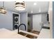 Stylish kitchen showcasing quartz countertops, stainless appliances, and a stacked washer-dryer at 1002 S Locust Ave, Sanford, FL 32771