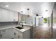 Bright kitchen with breakfast bar opens to a spacious living area and sliding glass door at 1002 S Locust Ave, Sanford, FL 32771