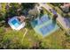 Aerial view showcases the community pool and tennis courts surrounded by lush greenery and landscaping at 106 Water Oak Dr, Sanford, FL 32773