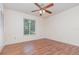 Bedroom featuring wood floors, ceiling fan, and a large window with natural light at 106 Water Oak Dr, Sanford, FL 32773
