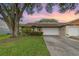 Charming one-story home with a well-manicured lawn, mature trees, and a two-car garage at 106 Water Oak Dr, Sanford, FL 32773