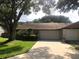 Charming single-story home featuring a well-maintained lawn, mature trees and a two-car garage at 106 Water Oak Dr, Sanford, FL 32773