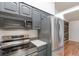 Modern kitchen featuring sleek stainless steel appliances and dark gray cabinetry at 106 Water Oak Dr, Sanford, FL 32773