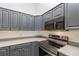 This kitchen features gray cabinets, a stainless steel oven, and light countertops at 106 Water Oak Dr, Sanford, FL 32773