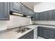 Kitchen featuring stainless steel sink, gray cabinets, and stylish countertops at 106 Water Oak Dr, Sanford, FL 32773