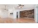 The home features laminated wood flooring and a wood accent wall in the open-concept living and dining area at 106 Water Oak Dr, Sanford, FL 32773
