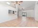 Open-concept living room showcases tile and laminated wood flooring and sliding glass doors to the exterior at 106 Water Oak Dr, Sanford, FL 32773
