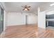 A spacious living room features laminated wood floors, high vaulted ceilings, and sliding glass door at 106 Water Oak Dr, Sanford, FL 32773