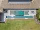 Aerial view of a pristine backyard pool, spa, and lounging area, complemented by a lush green lawn at 1112 Preserve Point Dr, Winter Park, FL 32789