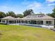 Expansive backyard with pool, covered patio, and ample green space, ideal for entertaining and recreation at 1112 Preserve Point Dr, Winter Park, FL 32789
