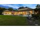Inviting back exterior with a pool, covered patio, and manicured lawn perfect for evening gatherings and relaxation at 1112 Preserve Point Dr, Winter Park, FL 32789