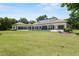 Expansive backyard with pool, covered patio, and ample green space, ideal for entertaining and recreation at 1112 Preserve Point Dr, Winter Park, FL 32789