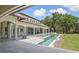 Beautiful backyard with a modern pool, well-manicured lawn and lush landscaping at 1112 Preserve Point Dr, Winter Park, FL 32789
