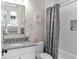 Bathroom features granite countertop, white vanity, and shower with curtain at 1112 Preserve Point Dr, Winter Park, FL 32789